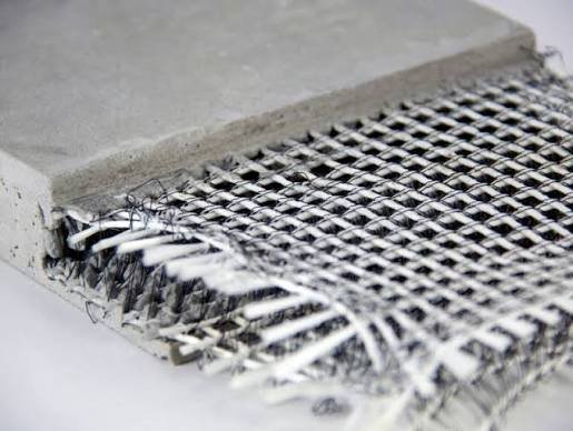 Fiberglass reinforcing mesh shown between layers of a construction sample